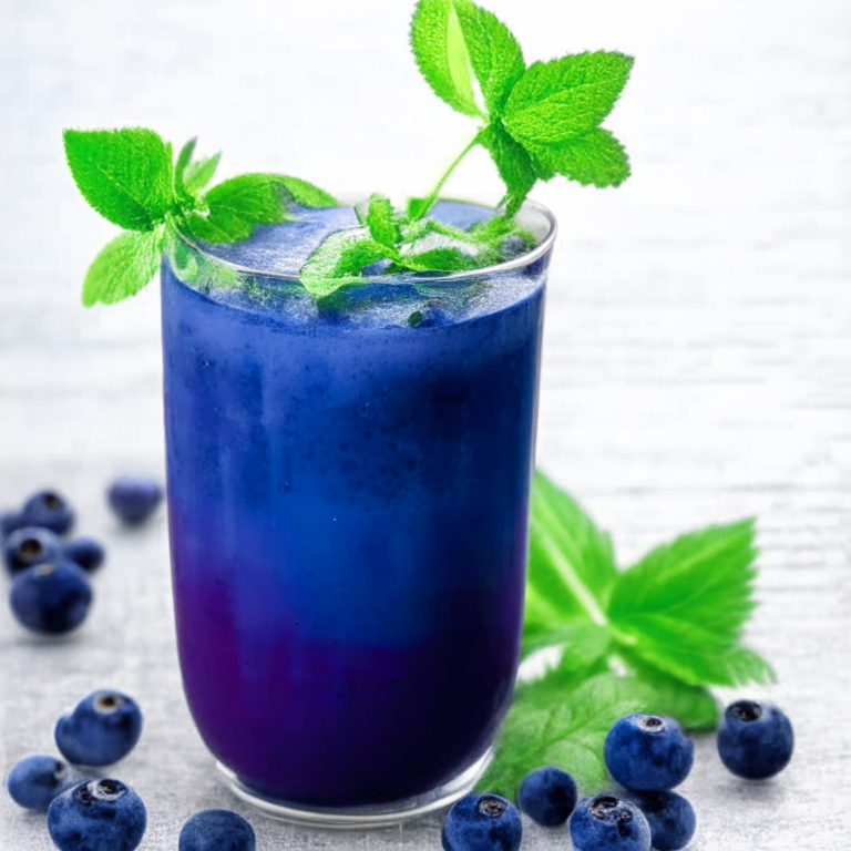 a picture of an Alkaline Blueberry Blast with blueberries and a sprig of mint