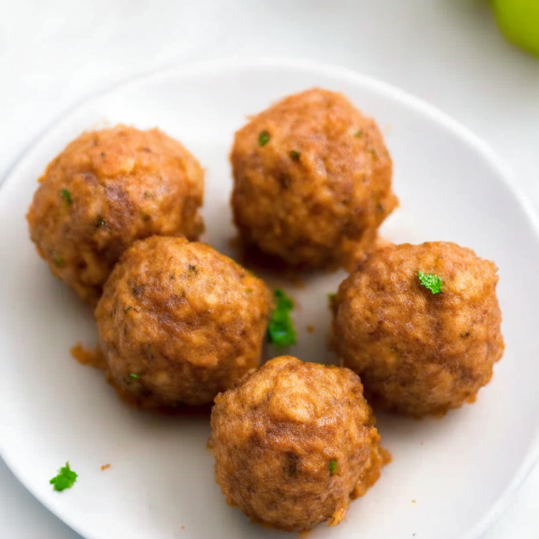 A plate-filling image of 6 air fryer turkey meatballs on a white plate