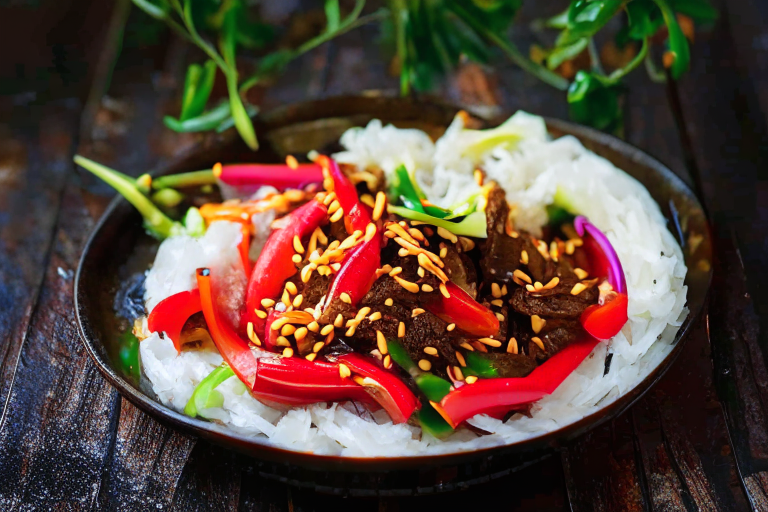 Pad Kra Tiem Prik Thai (Thai Garlic Pepper Beef Stir-Fry) on a perfectly circular plate
