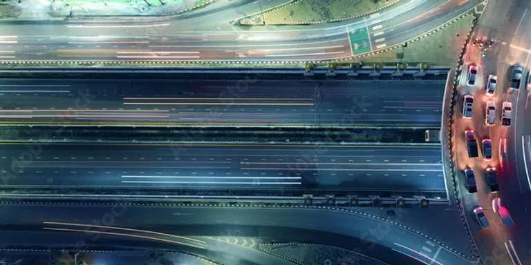 an aerial view of a highway intersection at night. motor vehicle, hood, light, automotive lighting, vehicle, automotive exterior, mode of transport, automotive design, grille, bumper