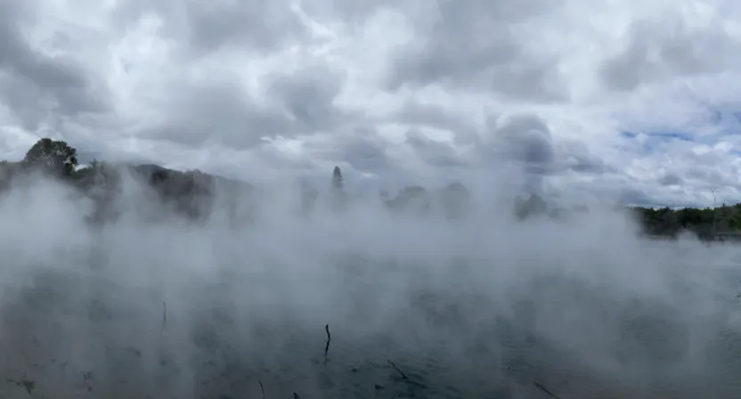 a large body of water surrounded by clouds