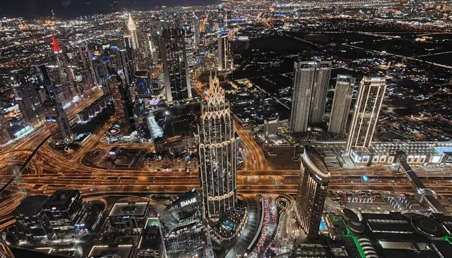 an aerial view of a city at night. skyscraper, building, tower, world, tower block, urban design, cityscape, thoroughfare, condominium, public space