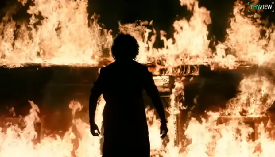 a person standing in front of a large fire