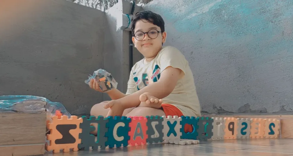 a young child sitting on the floor with a toy