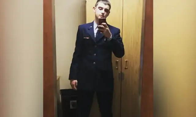 a man in a suit is taking a selfie