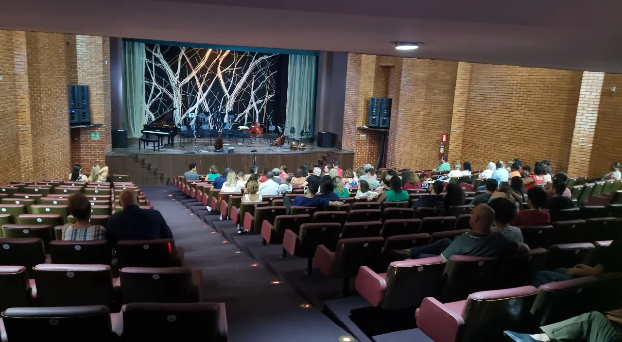 a group of people sitting in a large auditorium