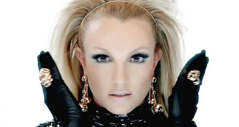 Highly detailed and hyper realistic Britney Spears in black outfit with beautiful intricate and detailed blonde hair blowing in the wind, ultra detailed face and ultra realistic Smokey eyes and make-up, 8k octane render, cinematic, musicvideo, beauty shot, professional studio lighting, 