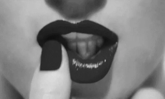 a black and white photo of a woman's mouth