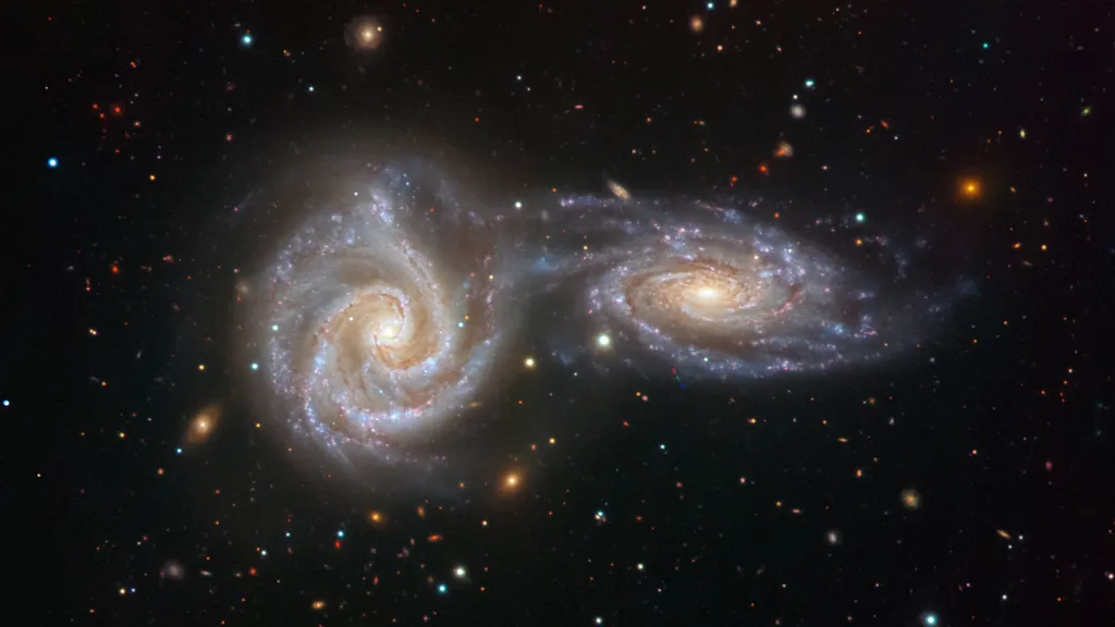 two spiral galaxies like objects in the sky. make it more stylised and abstract.