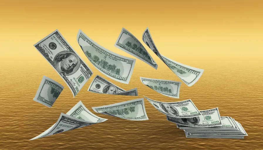 a bunch of money falling into the water