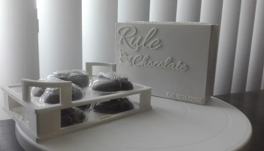 a white plate topped with cookies next to a box of chocolates