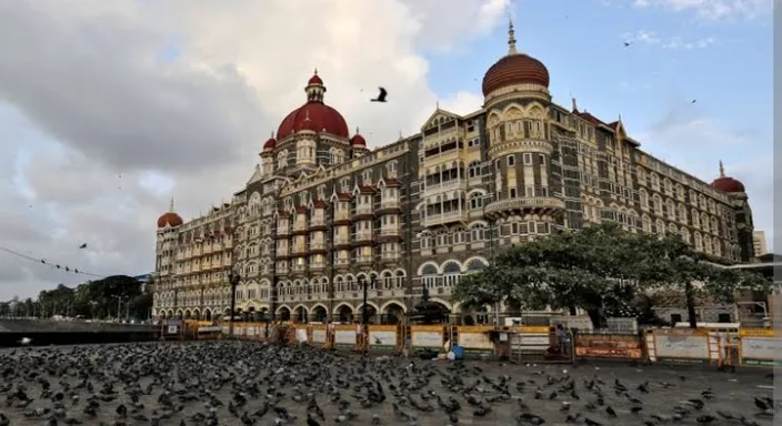 a large building with many birds in front of it