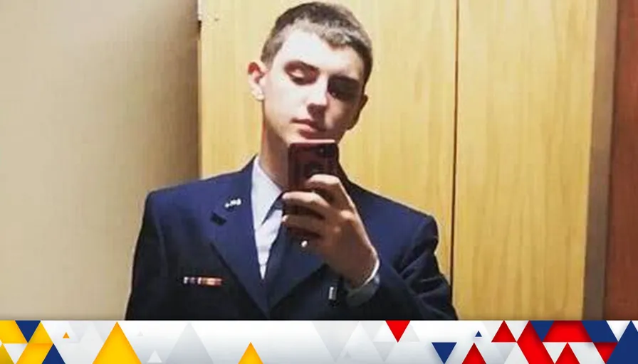 a man in a suit looking at his cell phone