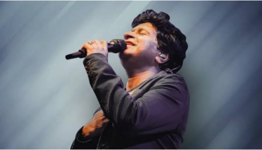 a man holding a microphone in his right hand