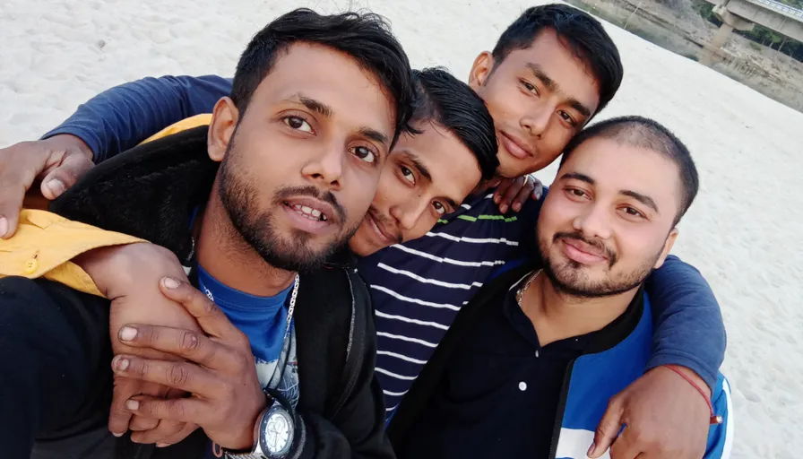 a group of men standing next to each other on a beach