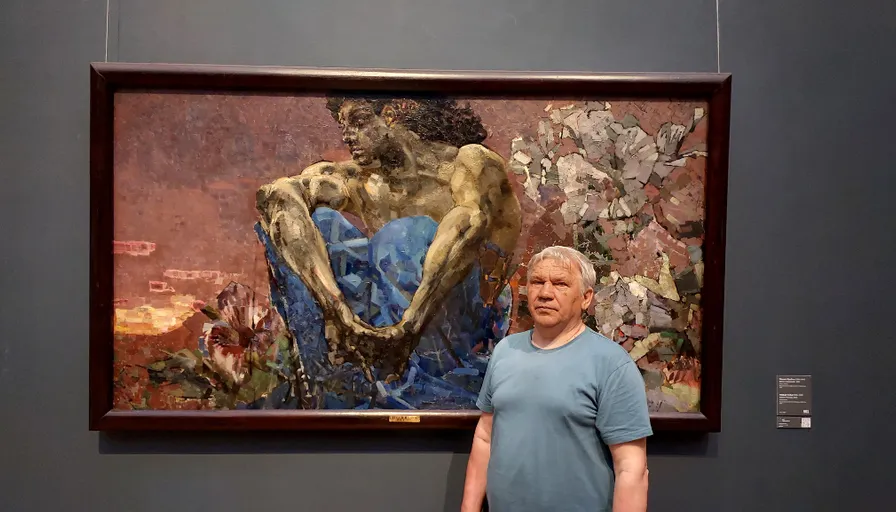 a man standing in front of a painting