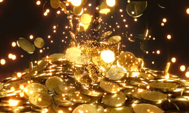 a pile of gold coins with lights coming out of them