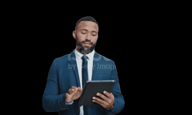 a man in a suit and tie using a tablet