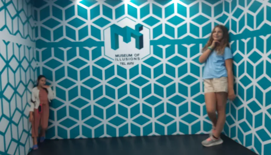 a woman standing in front of a blue and white wall