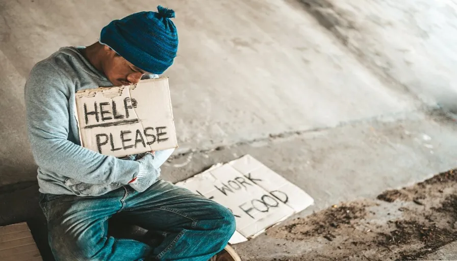 a man sitting on a step holding a sign that says help please