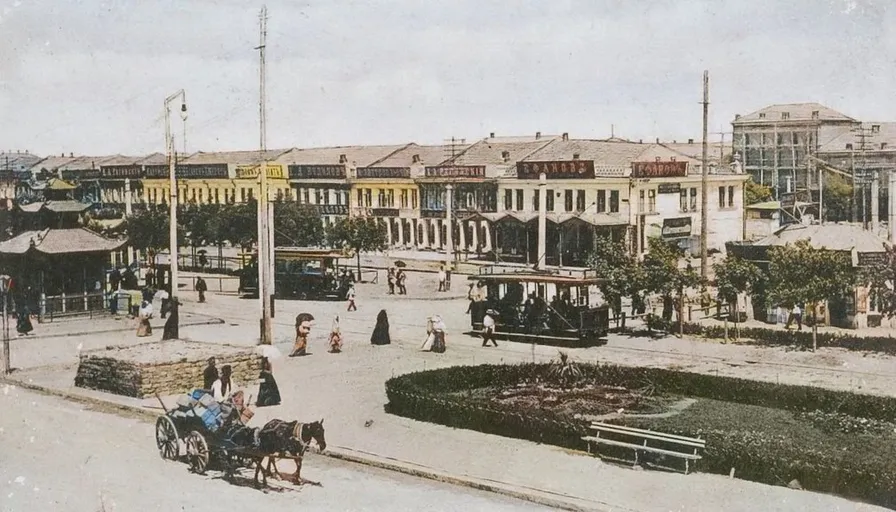 an old photo of a town square with a horse drawn carriage