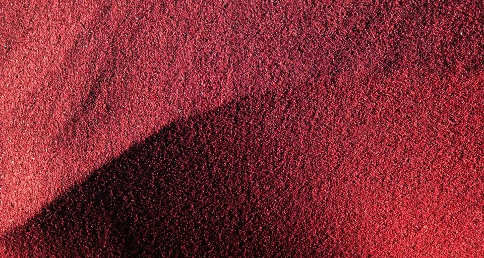 Close-up of volcanic ash spewing from a red and black crater