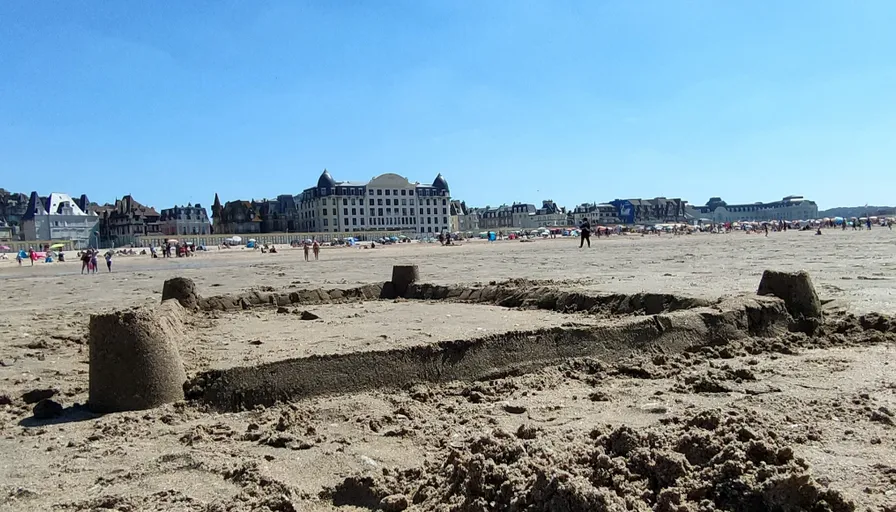 a sand castle sitting on top of a sandy beach