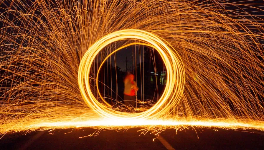 a person standing in front of a circle of fire