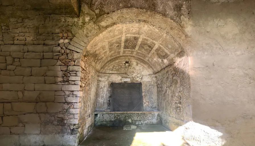 a tunnel in a stone building with a door