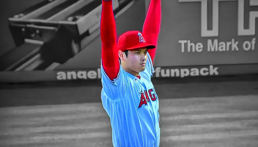 a baseball player raising his arms in the air