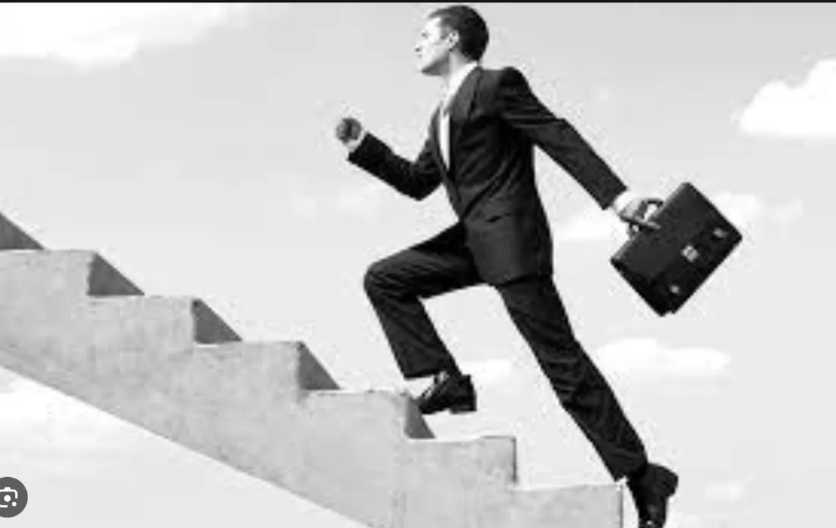 man in a suit running up at stairs 