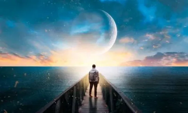 an image of a man standing on a pier in the ocean