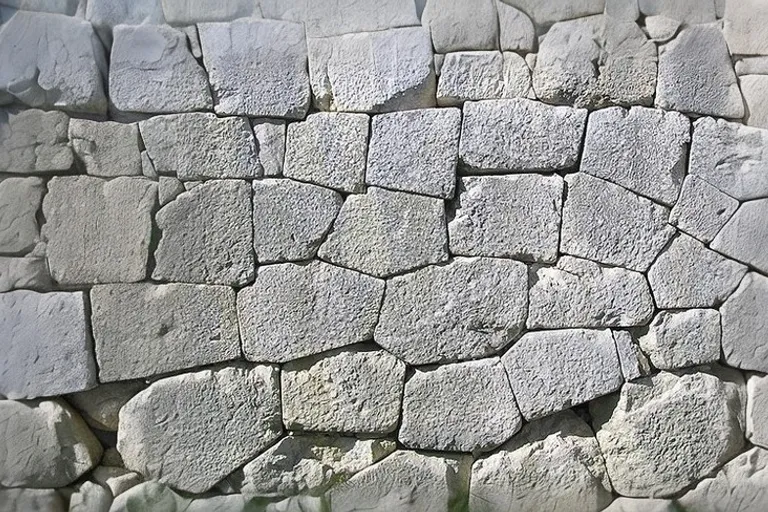 a stone wall made of rocks and cement