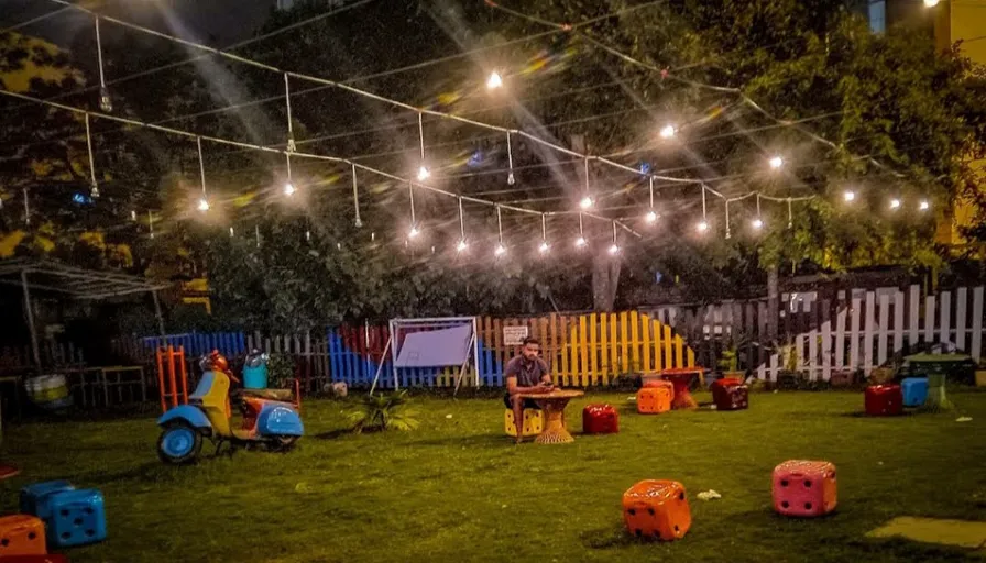 a group of children playing in a yard at night