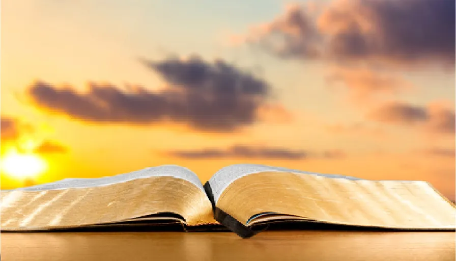 an open book sitting on top of a wooden table