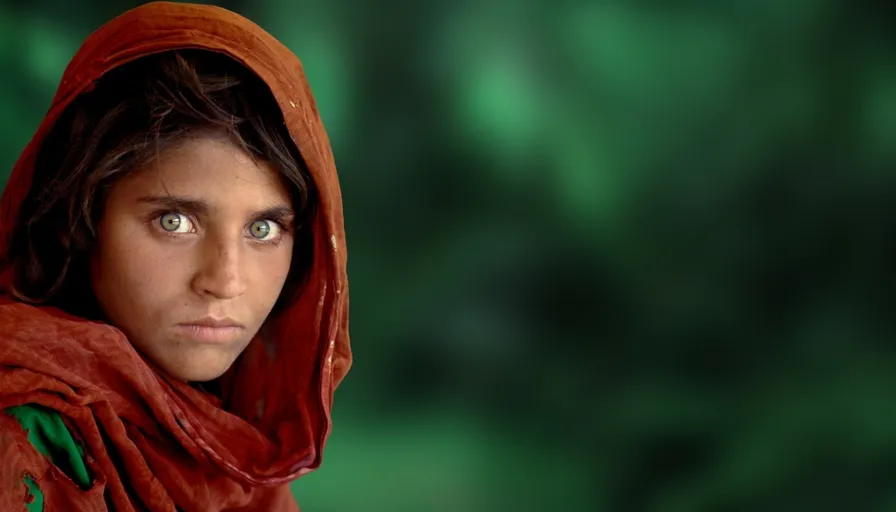 a young girl in a red shawl stares into the camera