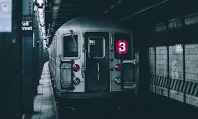 a subway train pulling into a train station