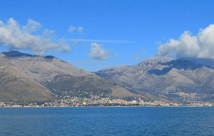 a body of water with mountains in the background