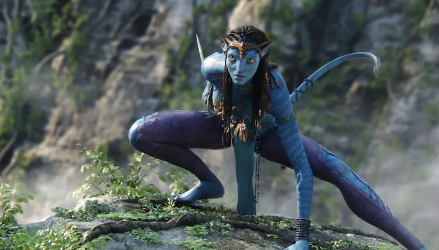 a woman dressed in blue and purple poses on a rock