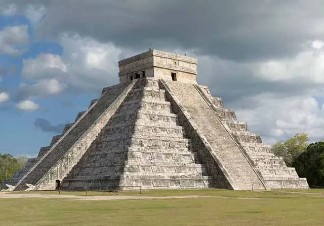 a large pyramid in the middle of a field