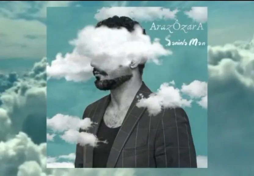 a man with a beard standing in the clouds