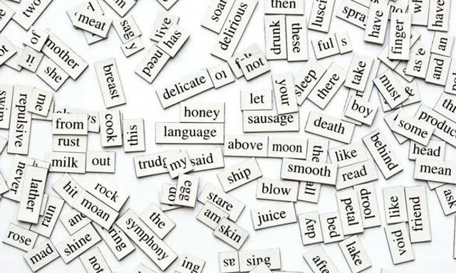 a bunch of words that are on a table falling to the ground