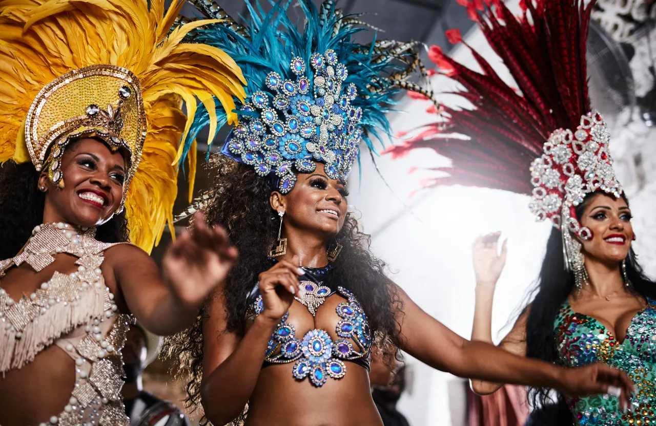 women dressed in colorful costumes and headdress, dancing