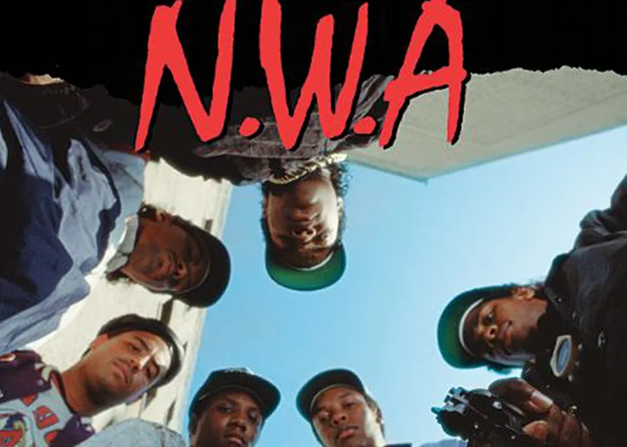 a group of men standing next to each other. gesture, hat, red, eyewear, font, camera, event, t-shirt, team, beard