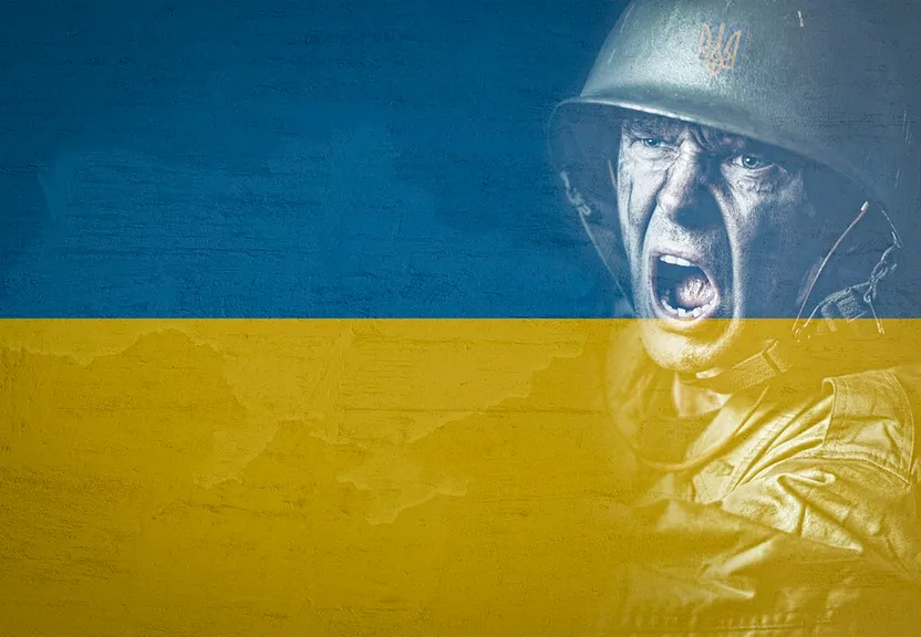 a man wearing a helmet and holding a yellow and blue flag