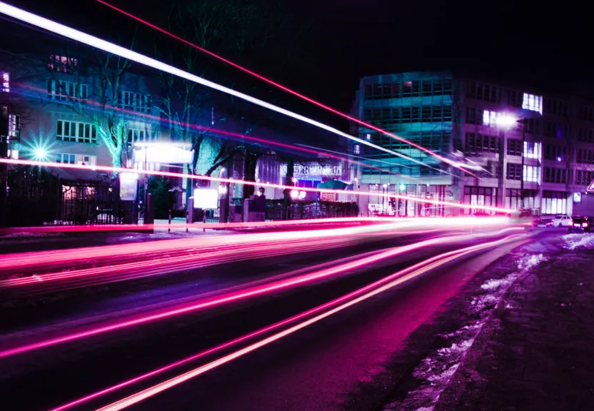 a blurry photo of a city street at night