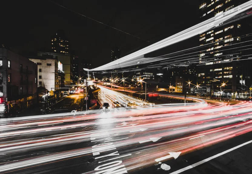a city street filled with lots of traffic at night