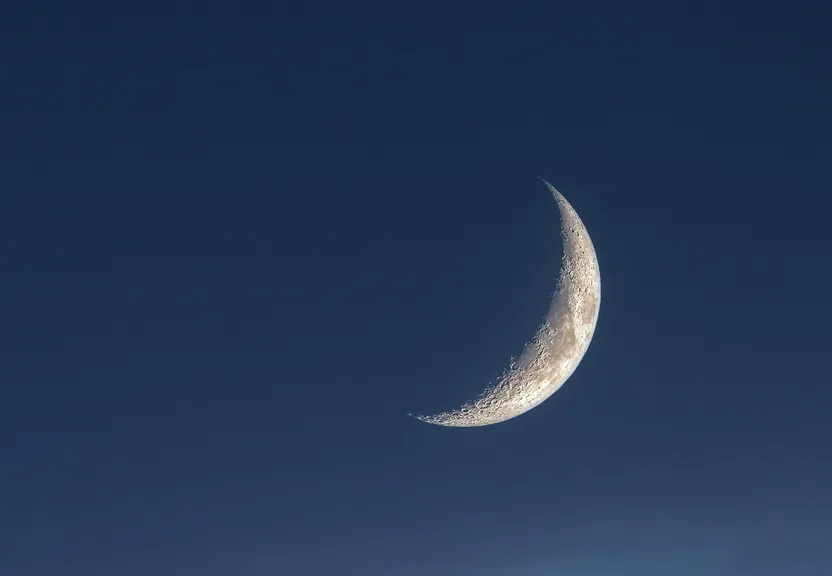 a half moon is seen in the sky