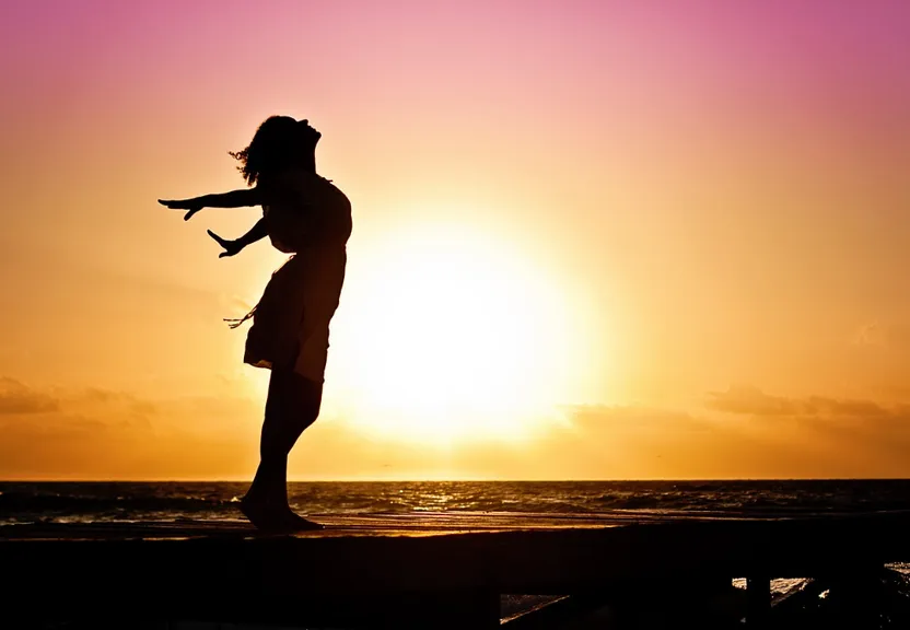 a silhouette of a woman standing on a dock at sunset