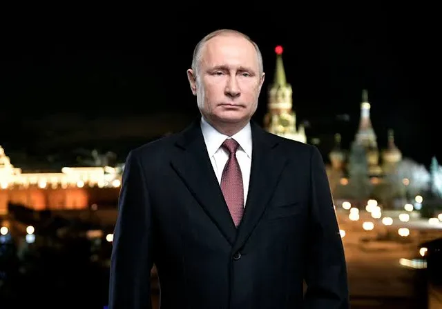 a man in a suit and tie standing in front of a cityscape